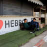 Palestinians sit near the closed entrance of Hebron, in the West Bank, October 24, 2026.
