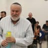 Former attorney-general Avichai Mandelblit walks into the courtroom at the Jerusalem District Court, October 25, 2026.