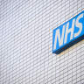 The logo of the National Health Service is seen on the exterior of St Thomas' Hospital on March 13, 2025 in London, England.