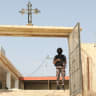 A member of the security forces stands guard during preparations for the funeral of victims of a church shooting in Karak, Jordan, October 25, 2026.