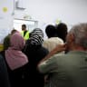 People stand in a queue to vote during the national election, at a polling station in the Arab village of Taibe, northern Israel, October 27, 2026