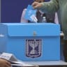 A voter places his ballot into a collection box during Israel's 26th Knesset elections, October 27, 2026.