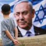 A child looks at a banner depicting Prime Minister and Likud party leader Benjamin Netanyahu, during the country's national elections in Jerusalem, October 27, 2026.