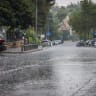 People walk in the rain in Jerusalem, August 15, 2026. 