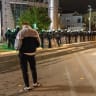 Riot police officers stand guard in front of the TV Pink building in Belgrade, Serbia, October 26, 2026.