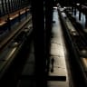 A worker walks on an empty platform next to trains following the collision of two high-speed trains between the towns of Mora and Orgaz, at Atocha train station in Madrid, Spain, October 28, 2026.