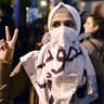 A Syrian refugee wears a scarf reading 'Freedom' while taking part in a demonstration in Athens calling for women rights on March 8, 2017, marking the International Women's Day.