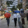 People walk in heavy rain along Jaffa Street in Jerusalem during Election Day, on October 27, 2026.