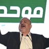 United Arab List (Ra’am) party chairman Mansour Abbas stands alongside fellow party members on stage following the release of exit poll results in the northern Israeli city of Sakhnin, on Israel’s general election night, October 27, 2026. 