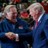 Republican US Senate candidate, former US Representative Mike Rogers shakes hands with US President Donald Trump during a rally, ahead of the midterm elections, at an entertainment complex in Port Huron, Michigan, US, October 25, 2026.