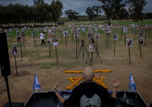  Pictures of the participants of the Nova party who were murdered and kidnapped by the terrorist organization Hamas on October 7, 2023 are displayed while an artist play music, at the site of the Nova music festival massacre, in Re'im, near the Israeli-Gaza border, November 28, 2023