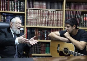  Israeli singer Idan Amedi (R), who was wounded fighting in Gaza, is seen speaking with Rabbi Yisrael Meir Lau.
