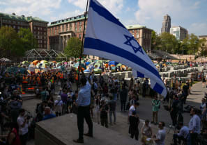 A counter protester waves an Israeli flag as students rally on Columbia University campus at a protest encampment in support of Palestinians in New York City, US, April 29, 2024. 
