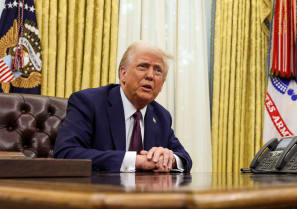  U.S. President Donald Trump sits in the Oval Office of the White House, as he signs executive orders, in Washington, U.S., January 23, 2025.
