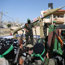 Members of Hamas ride on a truck as they display a rocket during an anti-Israel rally in Rafah, in the southern Gaza Strip May 28, 2021