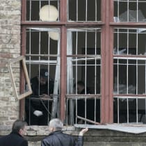 Investigators inspect an office where a grenade exploded in Kiev March 11, 2009. An unidentified attacker hurled a grenade through the window of an office linked to Kiev's main railway station, wounding seven people, Ukrainian security forces said.