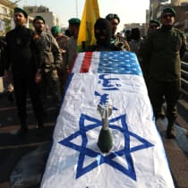  Members of Basij paramilitary forces hold a coffin with the Israeli flag during a rally in support of Palestinians, in Tehran, Iran, November 24, 2023.