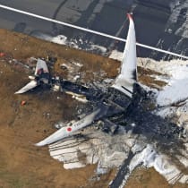  An aerial view shows burnt Japan Airlines' (JAL) Airbus A350 plane after a collision with a Japan Coast Guard aircraft at Haneda International Airport in Tokyo, Japan January 3, 2024, in this photo taken by Kyodo.