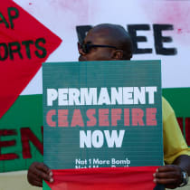  A man holds a placard which accuses Israel of genocide in the Gaza war, at the International Court of Justice in the Hague, in Cape Town, South Africa, January 10, 2024