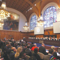  PEOPLE LISTEN to the proceedings inside the ICJ yesterday, in The Hague.