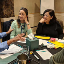  Hibaaq Osman (L) meets with Karama staff members. (Courtesy)