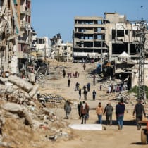  PALESTINIANS WALK past the ruins of houses destroyed during the Gaza war, in Gaza City, last month. 