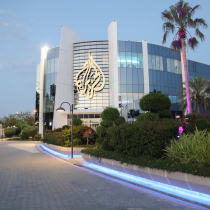  A man walks near an Al Jazeera building in Doha, Qatar, May 5, 2024. 
