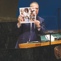  AMBASSADOR GILAD Erdan holds up photos of women hostages, showing the how they looked before they were taken captive on October 7 and how they look in captivity, during an addresses to the UN General Assembly in January. 