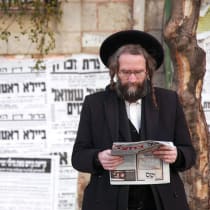  A haredi man reads a newspaper in Jerusalem’s Mea She’arim neighborhood.