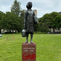  Statue of Anne Frank in Amsterdam, defaced with "Gaza" in red.