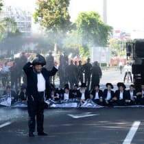  Police officers in Bnei Brak, Israel use water cannons as haredi Orthodox Jewish men block a main highway to protest efforts to allow the state to draft Haredi yeshiva students into military service, June 2, 2024.