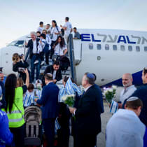  NEW IMMIGRANTS from France arrive at Ben-Gurion Airport, last month. To move to Israel, to live in Israel, and to build Israel are all steps in the messianic process, says the writer.