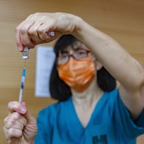  A woman is seen preparing a dose of the COVID vaccine.