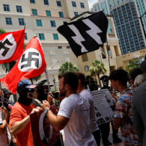 People waving Nazi swastika flags argue with conservatives during a protest outside the Tampa Convention Center, where Turning Point USA's (TPUSA) Student Action Summit (SAS) is being held, in Tampa, Florida, U.S. July 23, 2022. 