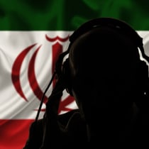  The silhouette of a man, seen over the flag of the Islamic Republic of Iran (illustrative)