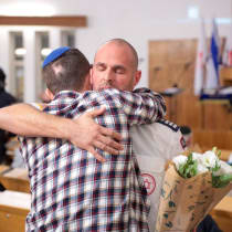  The MDA paramedic, Menachem, hugging one of the people injured in the attack.