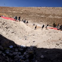  People carry their belongings while crossing from Lebanon into Syria, as they flee the ongoing hostilities between Hezbollah and Israeli forces, at the Masnaa border crossing, Lebanon October 28, 2024. 