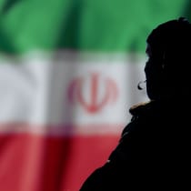  An illustrative image of an Iranian agent in the backdrop of an Iranian flag.