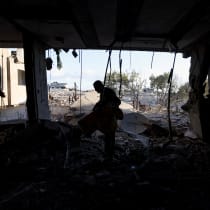  A Palestinian inspects the damage at the site of an Israeli strike, amid the Israel-Hamas conflict, at the Nuseirat refugee camp in the central Gaza Strip, December 13, 2024.