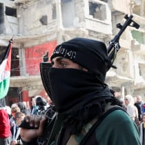  A man carries a weapon during a protest organized to celebrate the announcement of the ceasefire in Gaza, at Yarmouk camp in Damascus, Syria January 17, 2025. 