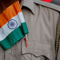 An Indian flag is pictured in the pocket of a police officer's uniform as he attends a rally in support of the Indian armed forces, following the ceasefire announcement between India and Pakistan, in New Delhi, India, May 13, 2025.