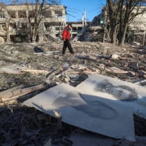 A resident walks near a school building destroyed during Russian air strikes, amid Russia's attack on Ukraine, in the town of Sloviansk, Donetsk region, Ukraine November 25, 2025.