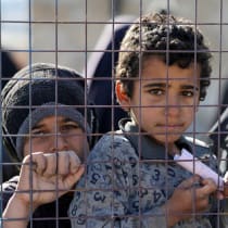 CHILDREN, PART of a group of detainees, look through a fence at al-Hol camp after the Syrian government took control of it following the withdrawal of Syrian Democratic Forces (SDF), in Hasaka, Syria, January 21, 2026.