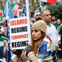 A demonstrator holds a placard during a protest against the Iranian government held by supporters of the Iranian royal family in exile, who marched through central London past the Iranian embassy to the Israeli embassy, in London, Britain, March 8, 2026