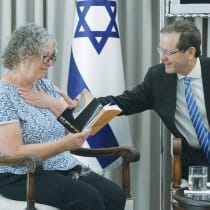 AVIVA SIEGEL reads an excerpt from her book to President Isaac Herzog. 