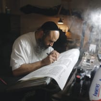 Scribe Nadav Elhadad writes a Torah scroll at Safed’s Mount Sinai Institute, in Feb.