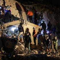 Emergency services work at the site of a collapsed building after earthquakes hit the country, in Caracas, Venezuela, June 24, 2026.