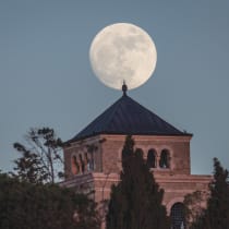 Shining: Moon rises behind the Mount of Olives, Jerusalem.