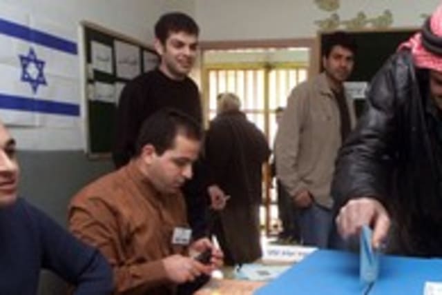 Israeli-Arab man casts his vote elections voting 300 (R) (photo credit: Ammar Awad / Reuters)