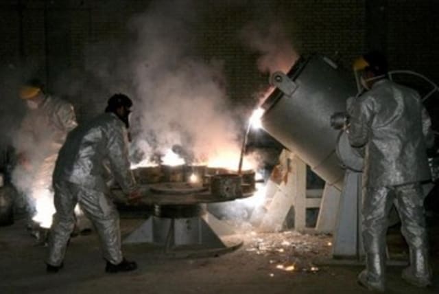 Iranian technicians work at a uranium processing site in Isfahan. (photo credit: REUTERS)